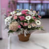 Pink and white mixed flower basket arrangement in a wicker basket