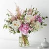 Pink and white bouquet in a clear glass vase