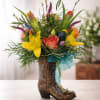 Colorful flower arrangement in a decorative cowboy boot vase
