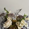 Cream roses and foxglove in a mixed floral arrangement