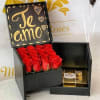 Black gift box with red roses and a chocolate box inside