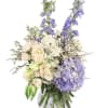 White and lavender floral arrangement in a clear vase