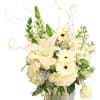 White floral arrangement in a glass vase with lilies and daisies