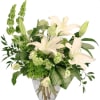 White lilies and green flowers in a clear glass vase