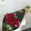 Bouquet of red roses with baby's breath in black wrap