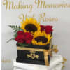Sunflowers and red roses arranged in a black gift box with gold ribbon