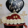 Heart-shaped box of red and white roses with chocolates and a love sign