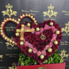 Heart-shaped rose arrangement with gold-wrapped chocolates in a red box