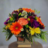 Bright mixed bouquet in a white pedestal vase