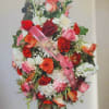 Large mixed floral standing spray with pink ribbon and butterfly accent
