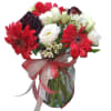 Bouquet of red gerbera daisies and white roses in a glass vase