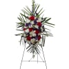 Standing floral spray with red, white, and purple flowers on an easel