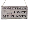 Hanging wooden sign that says "Sometimes I wet my plants"