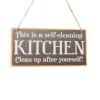 Hanging wooden sign with the words "This is a self-cleaning KITCHEN"
