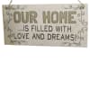 Hanging wooden sign reading "OUR HOME IS FILLED WITH LOVE AND DREAMS!"