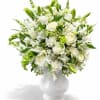White roses, lilies, snap dragons and carnations with bells of Ireland and