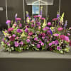 Large purple and pink floral arrangement on a table