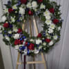 Standing wreath with red, white and blue flowers 