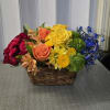 This vibrant floral arrangement features a cheerful mix of roses and seasonal