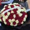 A luxurious bouquet made of red and ivory roses, symbolizing passion and