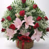 
A romantic arrangement of rich red roses and soft pink lilies, accented