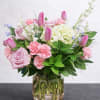 A soft and romantic garden-style arrangement featuring blush roses, pink tulips, hydrangea