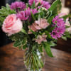 Soft pink roses and vibrant blooms in a fresh, elegant arrangement&mdash;perfect for