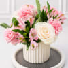 A graceful floral arrangement featuring premium white and blush pink roses, soft