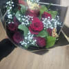 Bouquet of red roses with baby's breath in black wrap