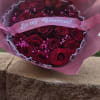 Bouquet of red roses with a pink "Be my Valentine?" ribbon and heart topper