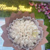Bouquet of pale cream roses wrapped in pink paper