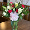 Mixed bouquet of pink and white flowers in a clear glass vase