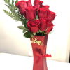 Red roses in a tall red gift box with a ribbon
