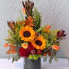 Sunflower and red rose arrangement in a dark vase