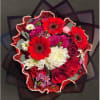 Combination of red white and pink flowers nicely arranged and wrapped in