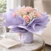 Pale pink roses nicely arranged and wrapped nicely with lavender wrapping.