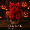 Red floral dog arrangement in a basket with Halloween decorations
