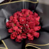 Bouquet of red roses wrapped in black paper with gold trim