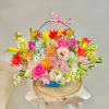 Colorful mixed flower basket with a pink ribbon handle