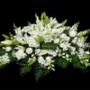 White floral casket spray with lilies and roses