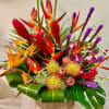 Tropical bouquet with red heliconia, orange bird of paradise, and purple orchids