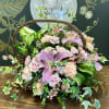 Basket arrangement with pink lilies, roses, and carnations