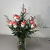 Pink-edged white roses arranged in a clear glass vase