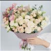 Large bouquet of pale pink and white roses with ribbon wrap
