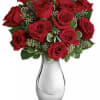 Red roses arranged in a clear glass vase