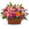 Basket arrangement with pink lilies, roses, and purple flowers
