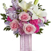 Pink roses and white lilies in a tall pink vase