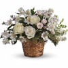 White roses and alstroemeria in a woven basket