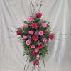 Tall standing spray of hot pink and light pink roses on a metal easel
