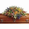 Colorful floral spray on a wooden casket